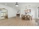 Well-lit living area with neutral decor, wood floors, a dining table and modern lighting at 6404 W Black Hill Rd, Phoenix, AZ 85083