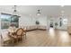 Open-concept living area with neutral décor, wood floors, a dining table and modern lighting at 6404 W Black Hill Rd, Phoenix, AZ 85083