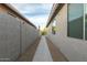 View of the home's side yard, showing neutral color walls and gravel at 6404 W Black Hill Rd, Phoenix, AZ 85083