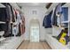 Large walk-in closet with custom shelving and a full-length mirror at 6404 W Black Hill Rd, Phoenix, AZ 85083