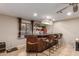 Stylish bar area with wooden accents, overhead lighting, and seating for entertaining guests at 6917 E Flossmoor Ave, Mesa, AZ 85208