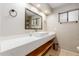 Modern bathroom with a trough sink, floating vanity, and sleek fixtures at 6917 E Flossmoor Ave, Mesa, AZ 85208