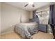 Cozy bedroom with soft lighting, tile floors, and a matching furniture set at 6917 E Flossmoor Ave, Mesa, AZ 85208