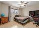 Bedroom with tile floor, ceiling fan, and natural light, perfect for rest and relaxation at 6917 E Flossmoor Ave, Mesa, AZ 85208