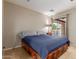 Comfortable bedroom featuring neutral tones, a ceiling fan, and exterior views at 6917 E Flossmoor Ave, Mesa, AZ 85208