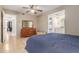 Inviting bedroom featuring neutral tones, a ceiling fan, and comfortable furnishings at 6917 E Flossmoor Ave, Mesa, AZ 85208