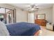 Well-lit bedroom with sliding door access, a ceiling fan, and comfortable furnishings at 6917 E Flossmoor Ave, Mesa, AZ 85208