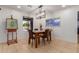 Cozy dining room with a modern chandelier, tile flooring, and a view to the backyard at 6917 E Flossmoor Ave, Mesa, AZ 85208