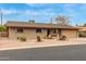 Well-maintained single-story brick home with desert landscaping and a two car garage at 6917 E Flossmoor Ave, Mesa, AZ 85208