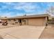 Spacious single-story brick home with a large driveway and desert landscaping at 6917 E Flossmoor Ave, Mesa, AZ 85208