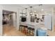 Open kitchen with a breakfast bar, pendant lighting, stainless appliances, and tile flooring at 6917 E Flossmoor Ave, Mesa, AZ 85208