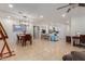 Open-concept living area with dining space, kitchen, and neutral tile flooring throughout at 6917 E Flossmoor Ave, Mesa, AZ 85208