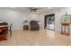 Bright living room with ceramic tile, neutral walls, and a sliding door to the backyard at 6917 E Flossmoor Ave, Mesa, AZ 85208