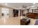 Spacious living room area features a large TV, ceiling fan, and a built-in bar area at 6917 E Flossmoor Ave, Mesa, AZ 85208