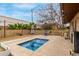 Backyard pool features a tiled patio, block wall, and a grill, offering a cozy outdoor retreat at 6917 E Flossmoor Ave, Mesa, AZ 85208