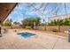 Cozy backyard with a small pool, surrounded by a stamped concrete patio, landscaping, and privacy walls at 6917 E Flossmoor Ave, Mesa, AZ 85208