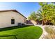 Well-maintained backyard featuring green grass and shaded areas with mature landscaping at 7849 W Kristal Way, Glendale, AZ 85308