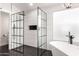 Modern bathroom featuring a walk-in shower, freestanding tub, and tiled walls at 7849 W Kristal Way, Glendale, AZ 85308