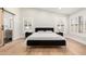 Bedroom featuring wood floors, vaulted ceilings and bright, shuttered windows at 7849 W Kristal Way, Glendale, AZ 85308