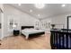Spacious bedroom with vaulted ceilings, wood floors, and bright, shuttered windows at 7849 W Kristal Way, Glendale, AZ 85308