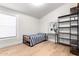 Bright bedroom with a comfortable twin bed, modern shelving, and a large window for natural light at 7849 W Kristal Way, Glendale, AZ 85308