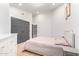 Bedroom featuring a light pink bed, hardwood floors, and gray closet doors at 7849 W Kristal Way, Glendale, AZ 85308