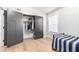 Bedroom with a twin bed, light hardwood floors, and a closet with gray doors at 7849 W Kristal Way, Glendale, AZ 85308