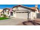 Beautiful single-story home with well-kept landscaping, an American flag, and a three car garage at 7849 W Kristal Way, Glendale, AZ 85308