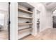 Hallway with built-in shelves, hardwood floors, and neutral paint at 7849 W Kristal Way, Glendale, AZ 85308