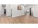 Spacious hallway with hardwood floors, white trim, leading to various rooms at 7849 W Kristal Way, Glendale, AZ 85308