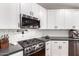 Modern kitchen featuring stainless steel appliances, subway tile backsplash and white cabinets at 7849 W Kristal Way, Glendale, AZ 85308