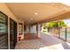 Charming covered patio featuring brick accents, recessed lighting, and access to a refreshing pool at 7849 W Kristal Way, Glendale, AZ 85308