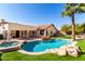 Stunning backyard pool and spa with rock features and lush landscaping, creating a private retreat at 7849 W Kristal Way, Glendale, AZ 85308