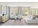 Bright living room with neutral tones, modern furniture, and view to outdoor space at 7975 W Griswold Rd, Peoria, AZ 85345