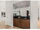 Stylish bar area with mirrored backdrop, granite countertop, and wood cabinets at 9112 E Palm Tree Dr, Scottsdale, AZ 85255