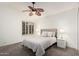 Bedroom with a ceiling fan, shuttered windows, and neutral tones create a serene atmosphere at 9112 E Palm Tree Dr, Scottsdale, AZ 85255