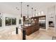 Spacious kitchen with an island, dark wood cabinetry, and stainless steel appliances at 9112 E Palm Tree Dr, Scottsdale, AZ 85255