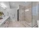 Bathroom featuring a frameless glass shower with marble tile and a double vanity with white countertops at 9677 E Gold Dust Ave, Scottsdale, AZ 85258