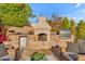 Outdoor kitchen with built-in fireplace, beverage cooler, and professional grill at 9677 E Gold Dust Ave, Scottsdale, AZ 85258