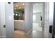 Bright bathroom featuring double sinks, white cabinets, and large shower with glass surround and tiled walls at 9685 W Patrick Ln, Peoria, AZ 85383