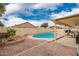 Backyard featuring a charming pool area with a covered patio and lush landscaping at 9859 W Irma Ln, Peoria, AZ 85382