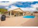 Relaxing backyard with a pool and covered patio, perfect for outdoor living and enjoyment at 9859 W Irma Ln, Peoria, AZ 85382
