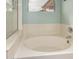 Bathroom with a white bathtub, light-blue painted walls and a window at 9859 W Irma Ln, Peoria, AZ 85382