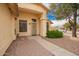 Covered front porch with security screen door and a small, well-kept garden at 9859 W Irma Ln, Peoria, AZ 85382