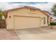 Side view of a two-car garage with tan stucco and tile roof at 9859 W Irma Ln, Peoria, AZ 85382