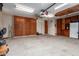 Spacious garage with ample storage cabinets, ceiling fan, and lighting, providing practical space at 9859 W Irma Ln, Peoria, AZ 85382