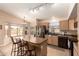 Open kitchen with a large island, stainless steel appliances, and a breakfast nook with views at 9859 W Irma Ln, Peoria, AZ 85382