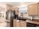 Well-lit kitchen featuring stainless steel appliances, a double sink, and ample counter space at 9859 W Irma Ln, Peoria, AZ 85382