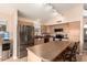 Spacious kitchen featuring stainless steel appliances, a center island, and ample cabinet space at 9859 W Irma Ln, Peoria, AZ 85382