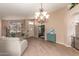 Bright living room with view of front door, tan carpet and neutral colored walls at 9859 W Irma Ln, Peoria, AZ 85382